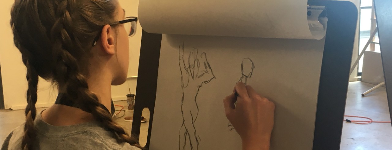student drawing on easel