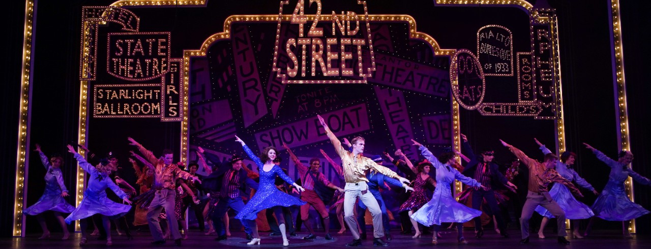 Actors dance on stage during CCM's production of "42nd Street"