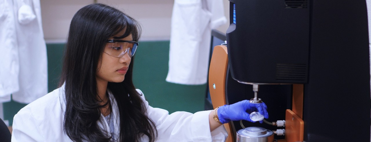 Vu Trang in lab working with chemicals 