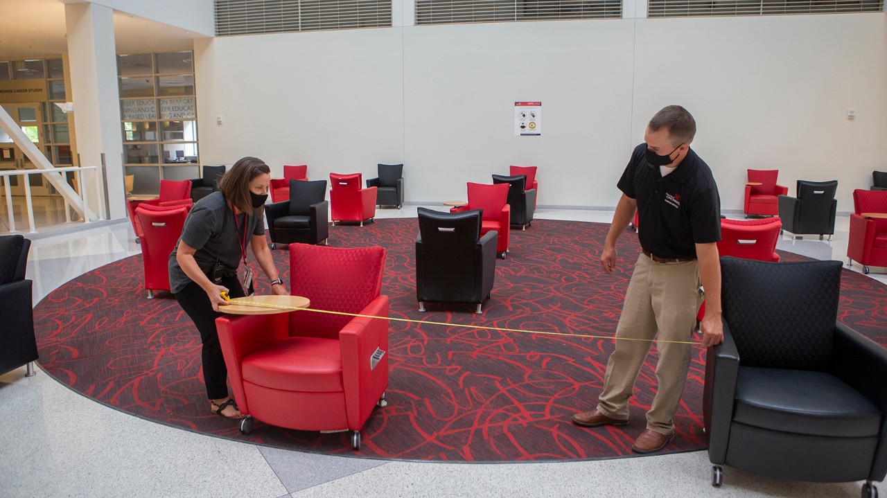 Staff arrange furniture in TUC lobby