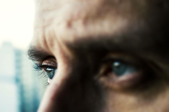 head shot of man's forehead and eyes thinking.