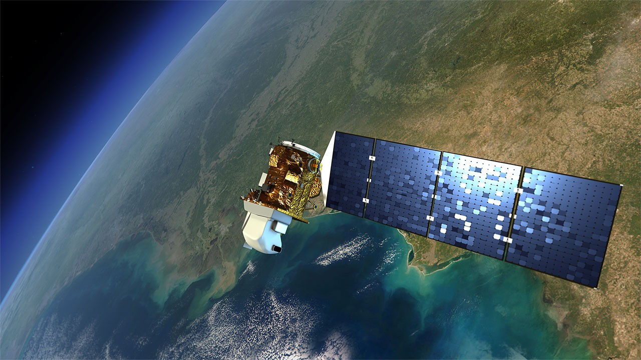 An artist's illustration of a Landsat satellite floating over the Pacific Ocean.