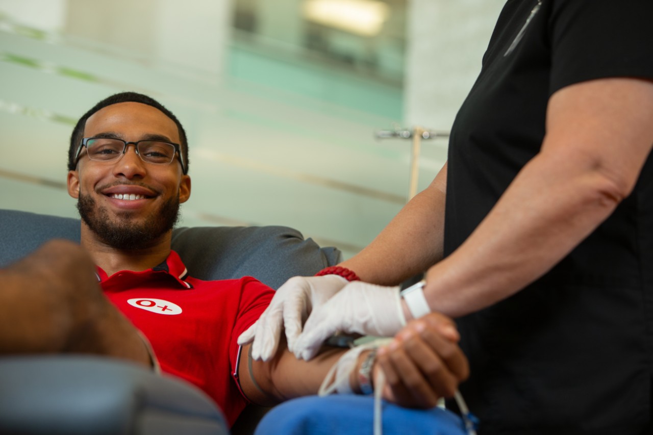 Male donor smiling during whole blood donation