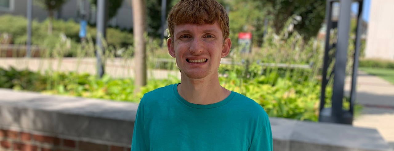 man outside with turquoise shirt