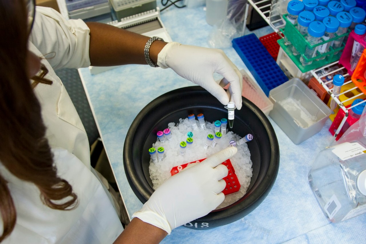 women holds test vials in generic lab shot
