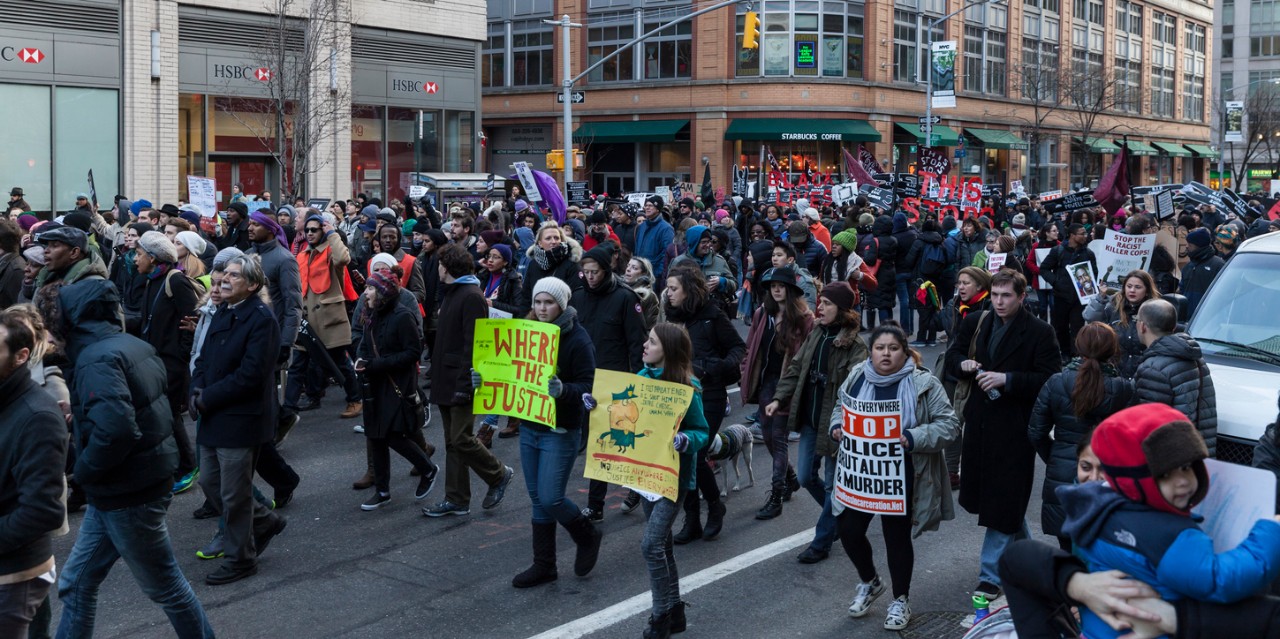 people marching in the streets with Black Lives Matter signs