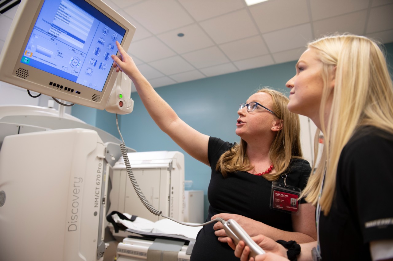 Advanced Medical Imaging technology professor teaching student how to use MRI machine