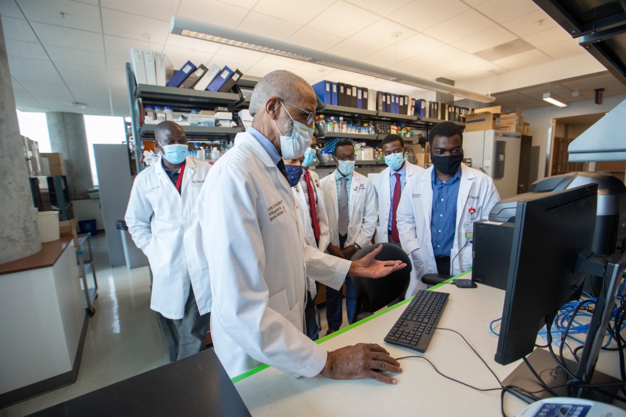 Alvin Crawford, MD, shown in a UC College of Medicine lab with medical students residents. 