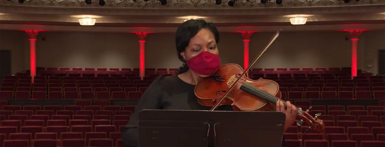 A violist performing on stage