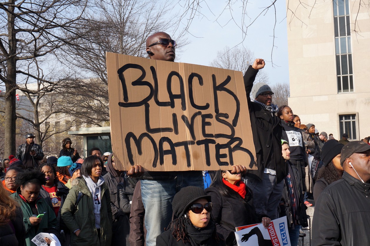 African American man holding up Black Lives Matter sign at protest