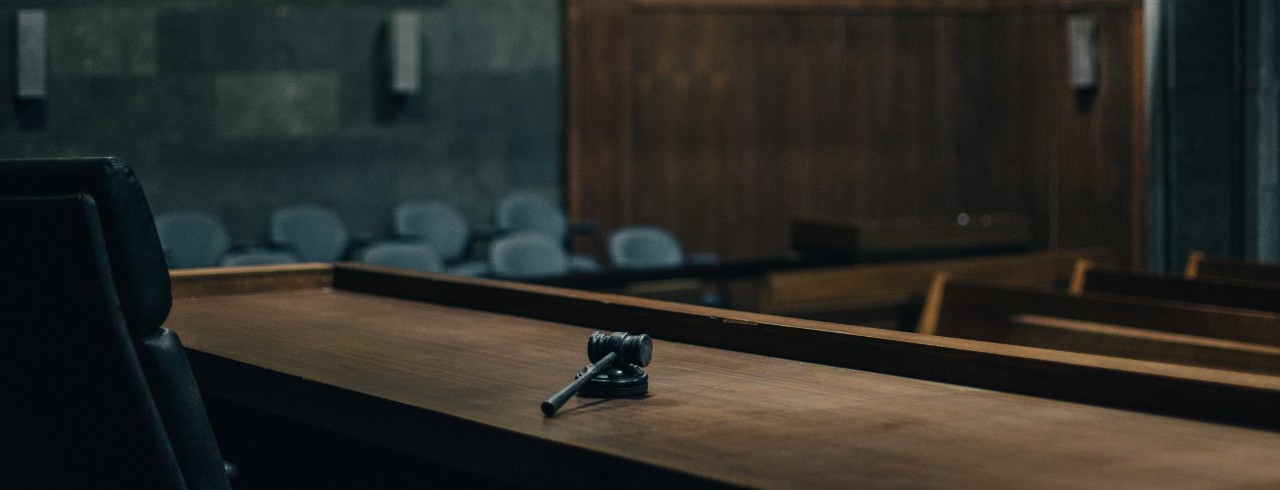 Judge's desk with gavel in an empty courtroom