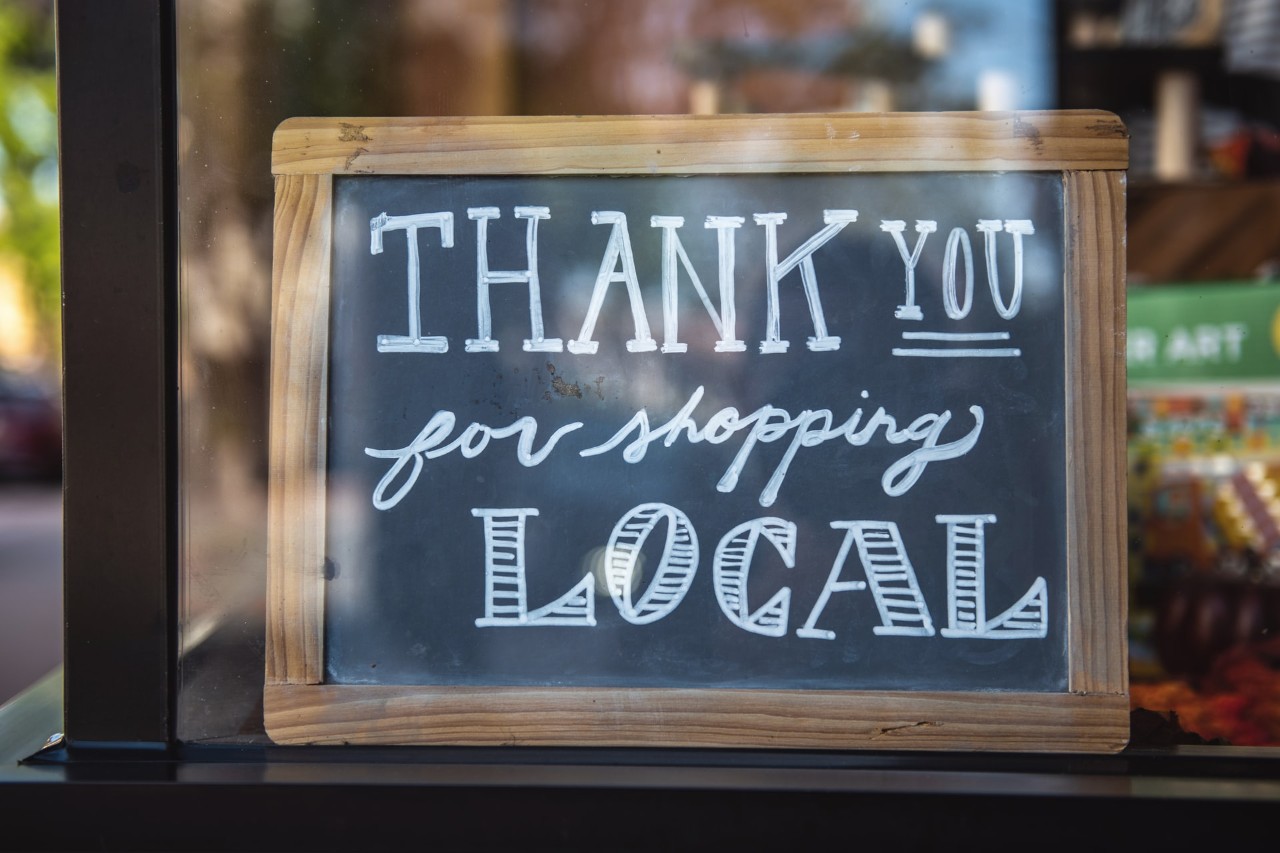 A sign that reads "Thank you for shopping local." 