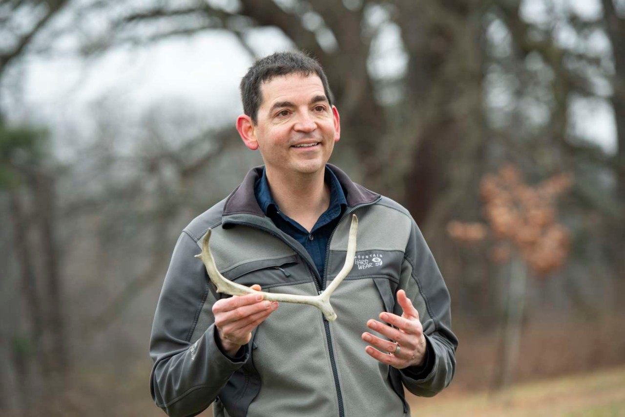 Joshua Miller holds caribou antlers