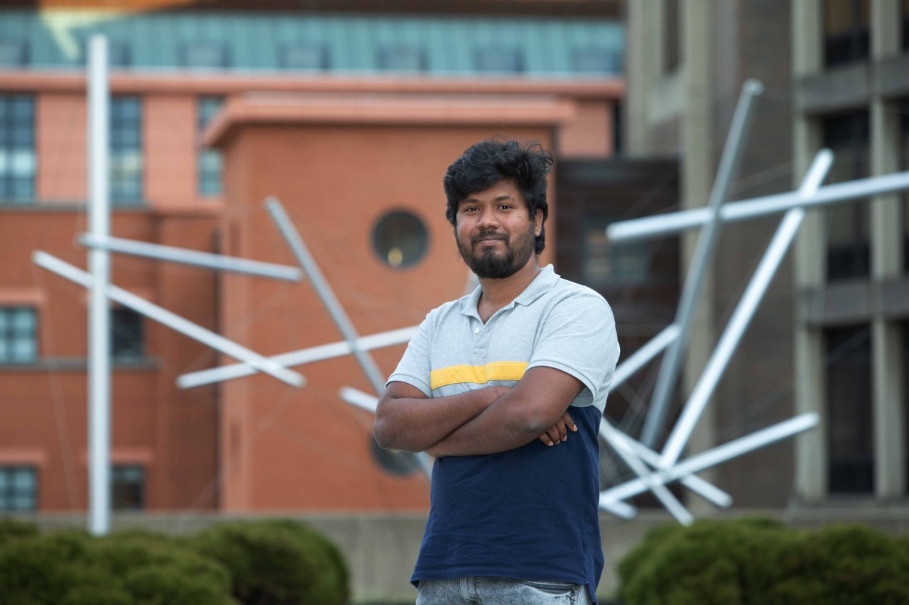 UC engineering student Arshad Mohammed stands in front of UC's Engineering Research Center.