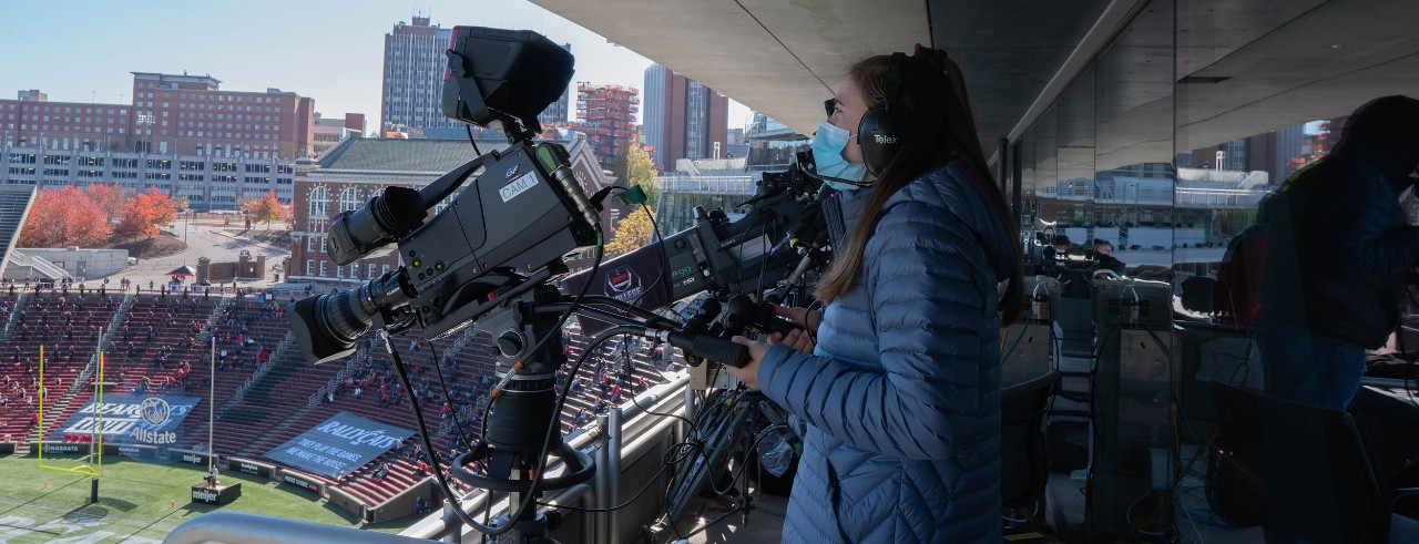 A student works on a ESPN+ sports broadcast in UC's Nippert stadium