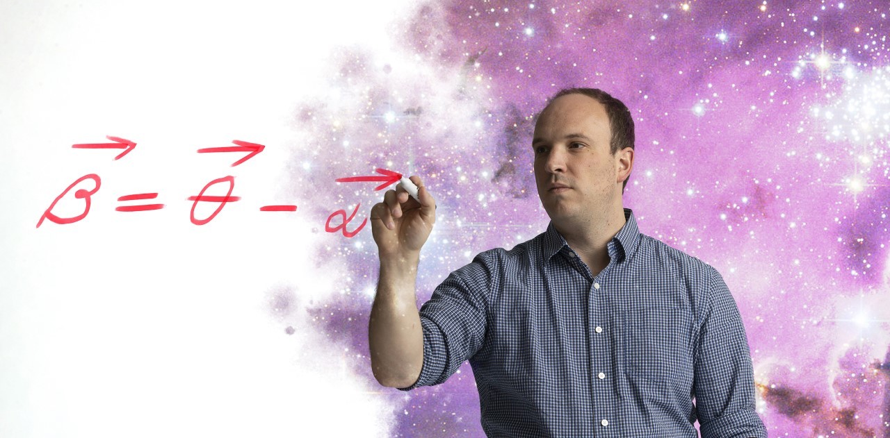 A photo illustration of Matthew Bayliss writing an equation with a starscape behind him.