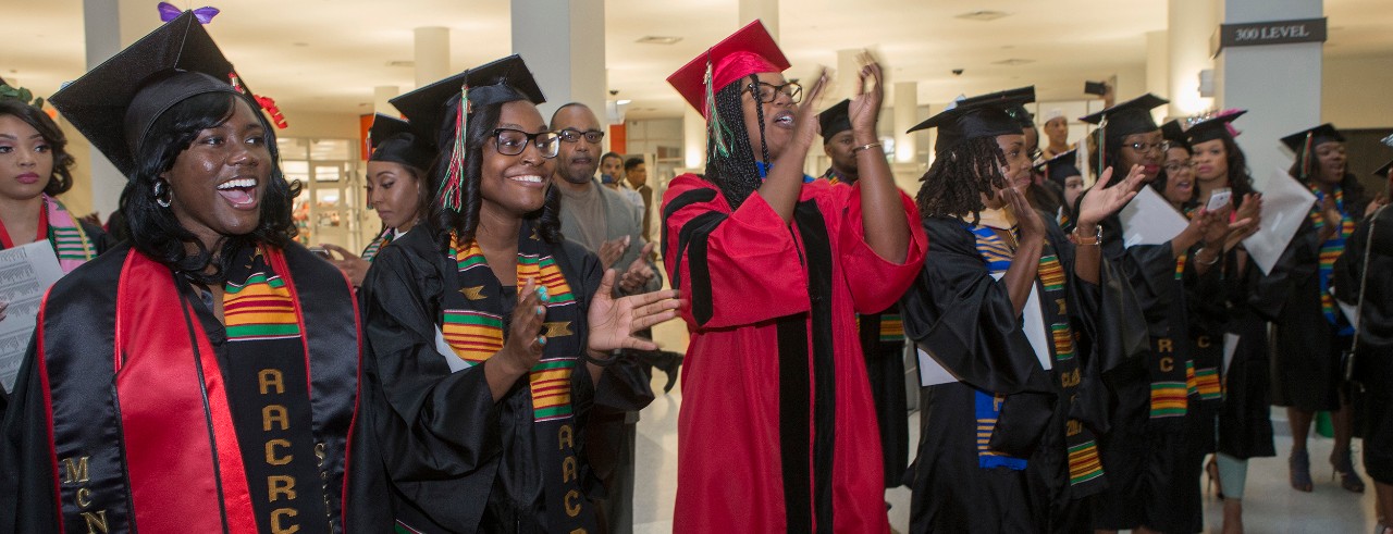 UC students and faculty celebrate Tyehimba in commencement regalia.
