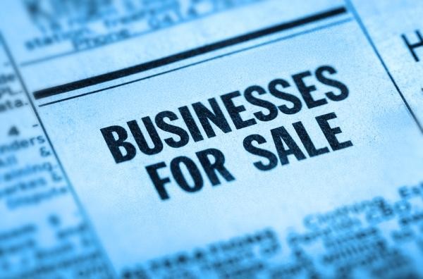 zoom in on "business for sale" ad in newspaper