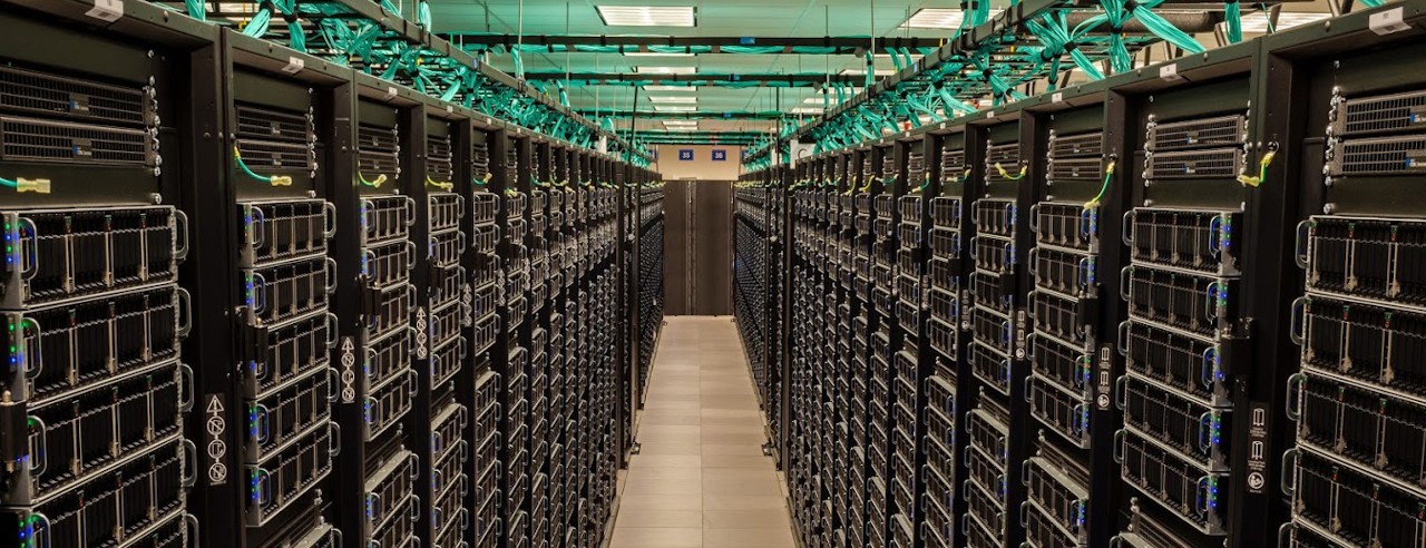 A view between two rows of the Frontera supercomputer's servers at the Texas Advanced Computing Center data center.