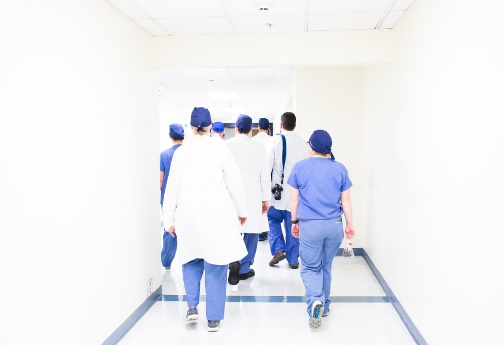 Medical students and residents walking in scrubs