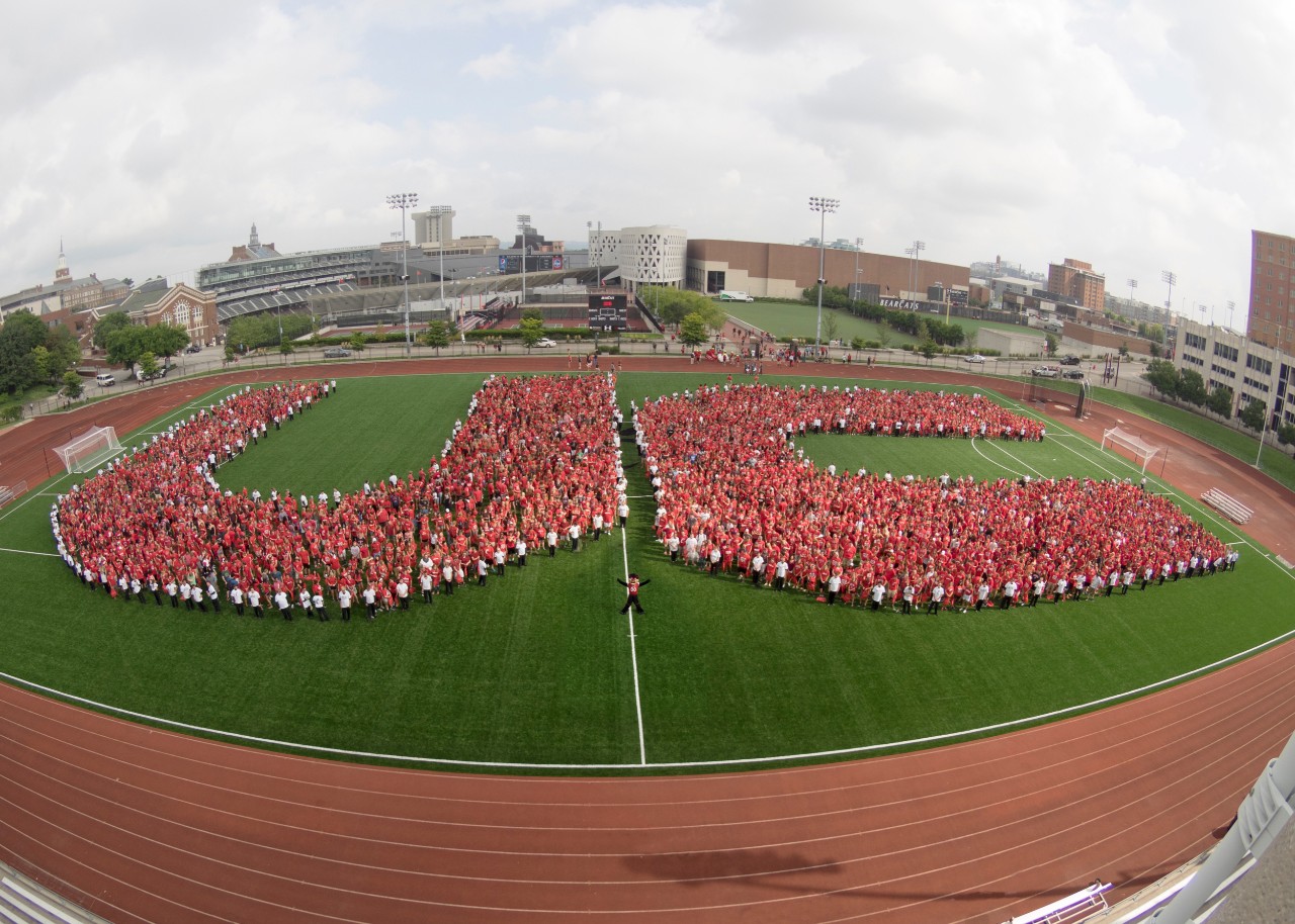 UC students spell out letters U-C on Gettler Field