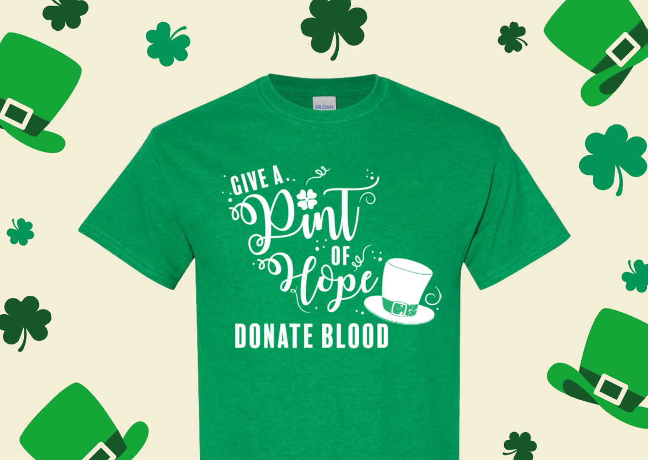 Green shirt with white text reading "Give a Pint of Hope" and a leprechaun hat