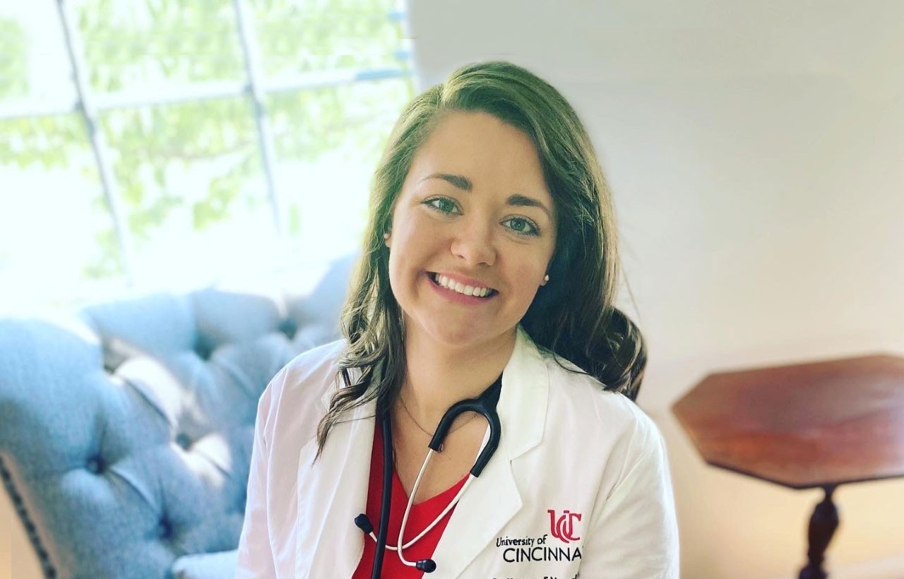 nursing student smiling in lab coat