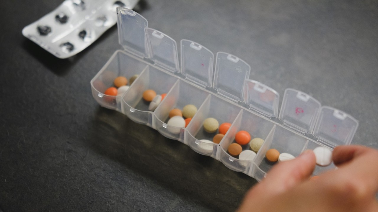pills in a daily medications container