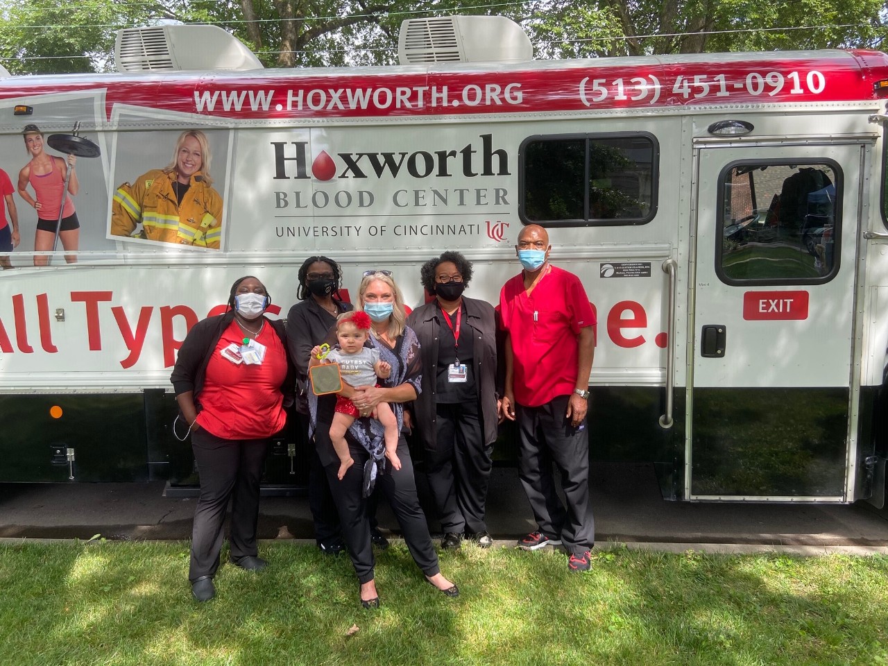 Brynn and Lindsay in front of Hoxworth bus during Brynn's Birthday Blood Drive