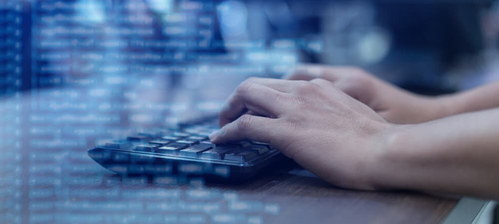 Hands typing on computer keyboard