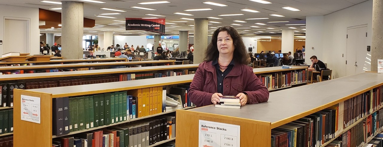 Arlene Johnson poses in UC's Langsam Library