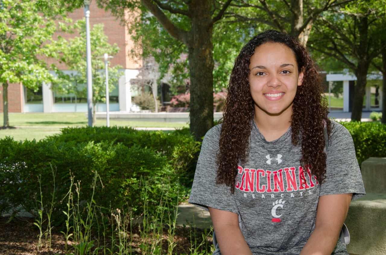 student wearing uc shirt smiling