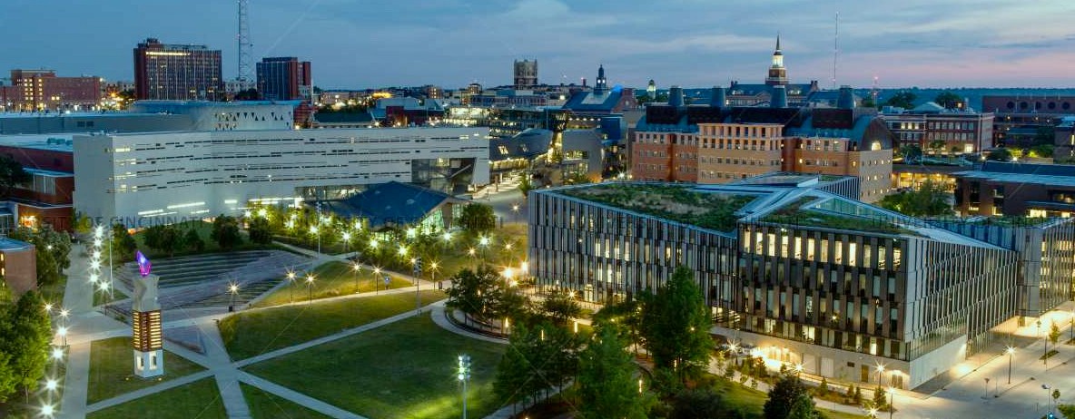 Aerial view of UC campus at night overlooking the green roof on LCOB