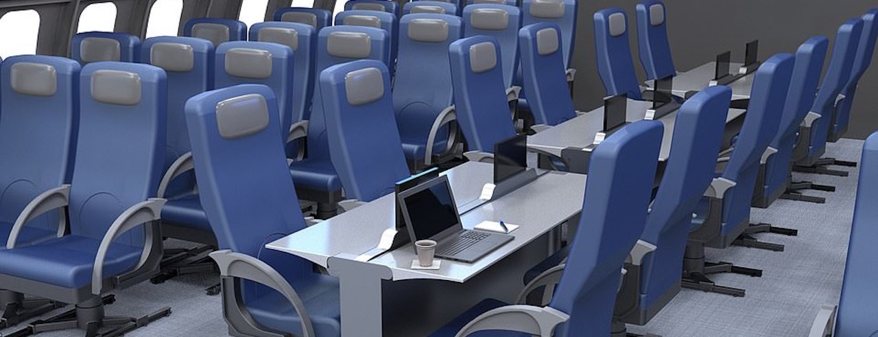 Plane cabin with long table rows