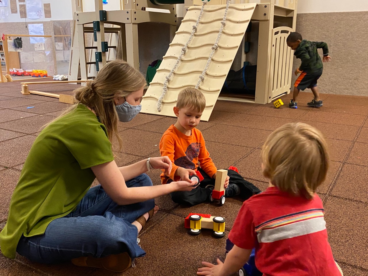 Hanna Berwanger, CECH '15, '20, works in the Phyllis Goldsmith Levinson Playroom at the Arlitt Center, an indoor gross-motor play space affectionately dubbed the "muscle room."
