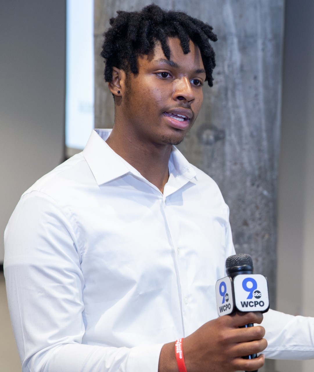 UC student Grant Chapel holds a WCPO-TV mic during an interview.