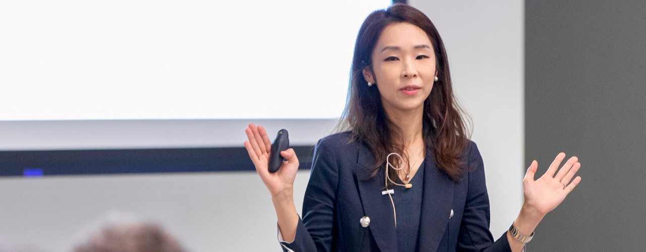 A woman, Yoonjee Park, stands in front of a panel of judges in the 1819 Innovation Hub Venture Lab..
