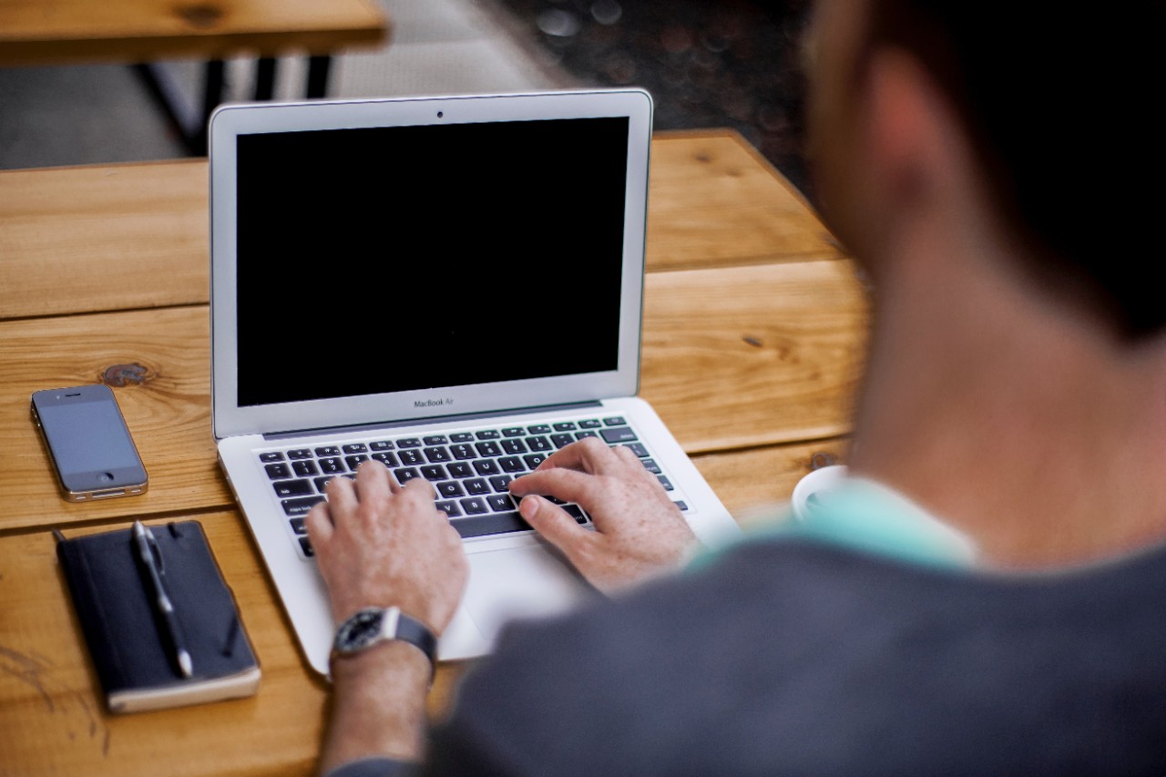 Student concentrates on studies on laptop.