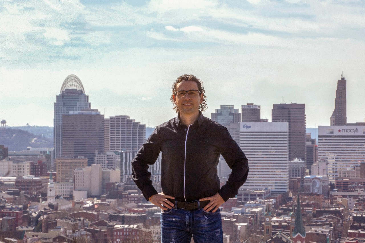 Diego Cuadros stands in front of the Cincinnati skyline.