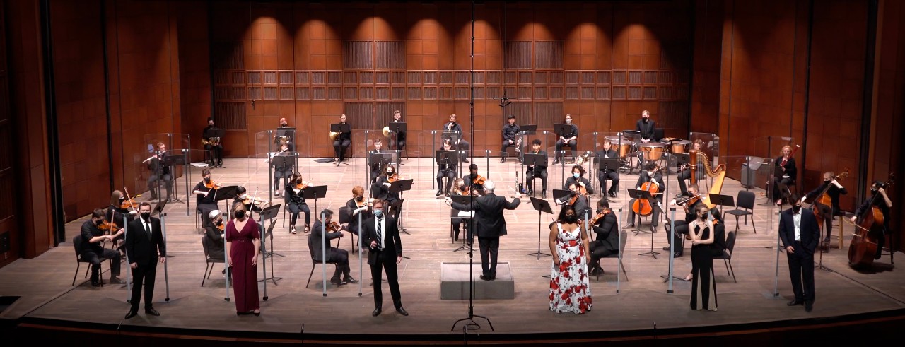 A still image from CCM's "Spring Opera Gala" performance broadcast, featuring six CCM singers on stage with the Philharmonia Orchestra. Photo/MasseyGreenAVP