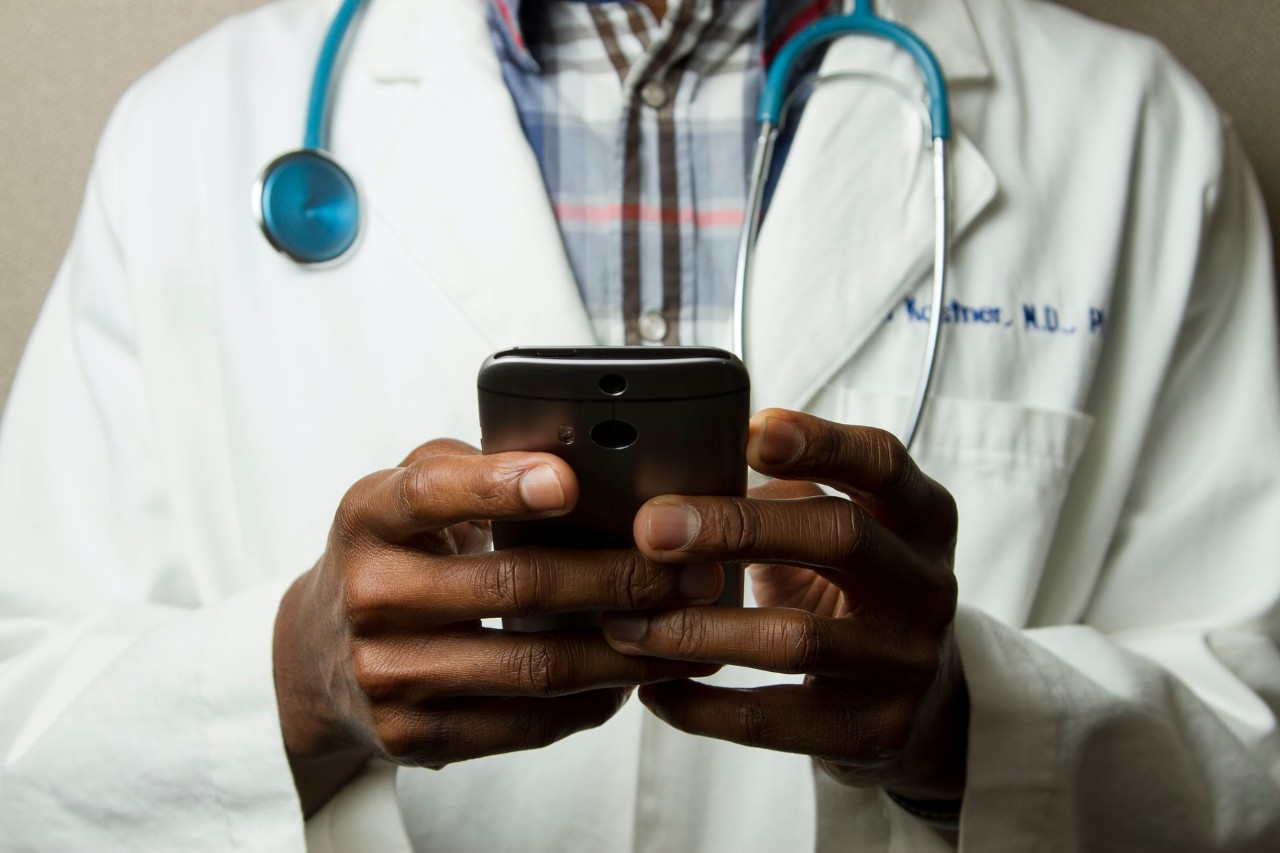 image of physician using a cellphone