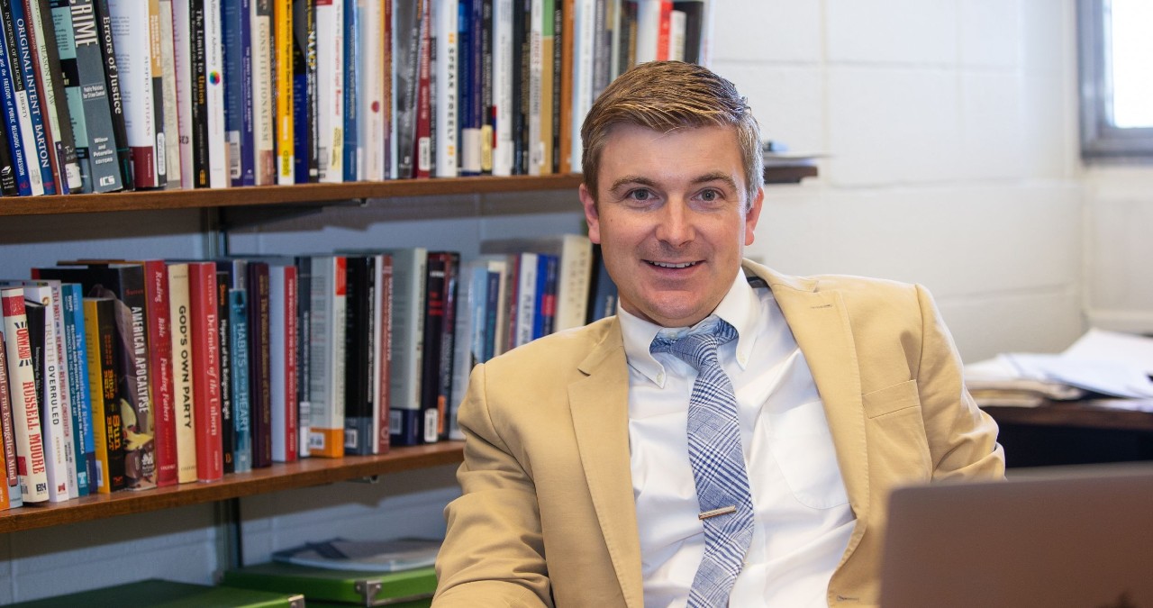 Political scientist Andrew Lewis in his office on UC's campus