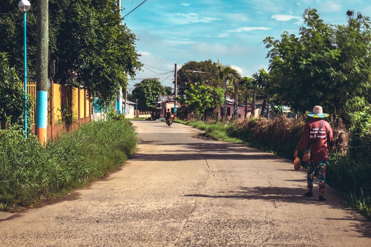 Person walking in a village in the Phillipines.