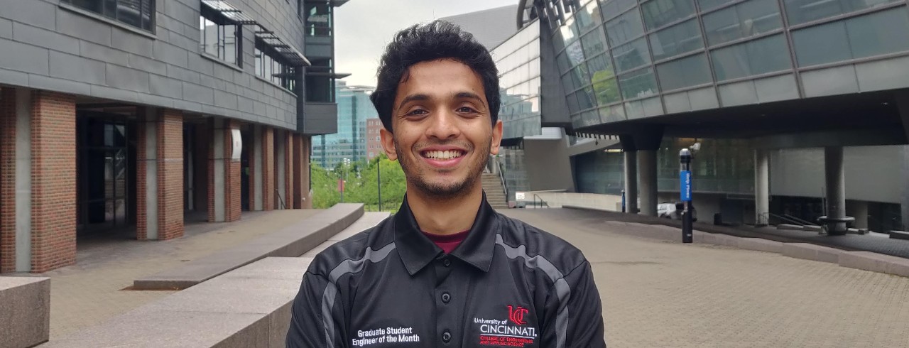 Parikshit Boregowda stands outside on college campus