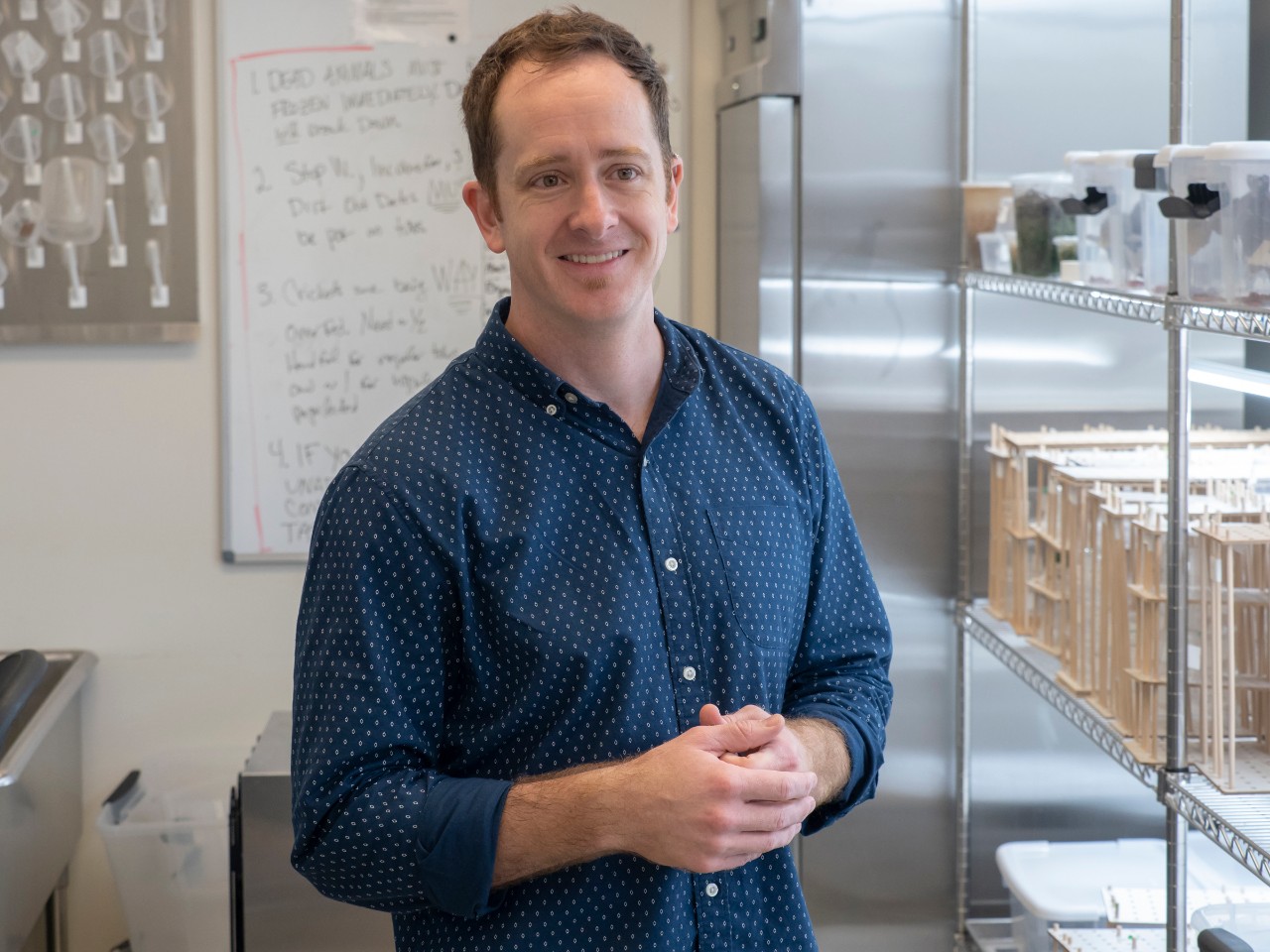 Nathan Morehouse stands in his spider lab.