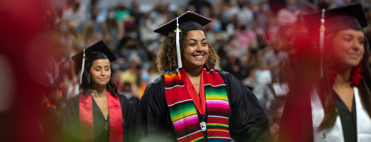 A UC grad takes part in Commencement at Fifth Third Arena.