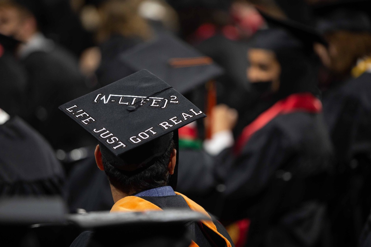 A mortarboard reads the square root of life squared: life just got real.