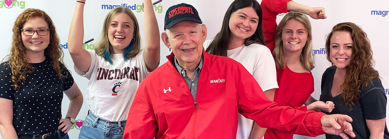 Roger Grein shown with a group of UC students.