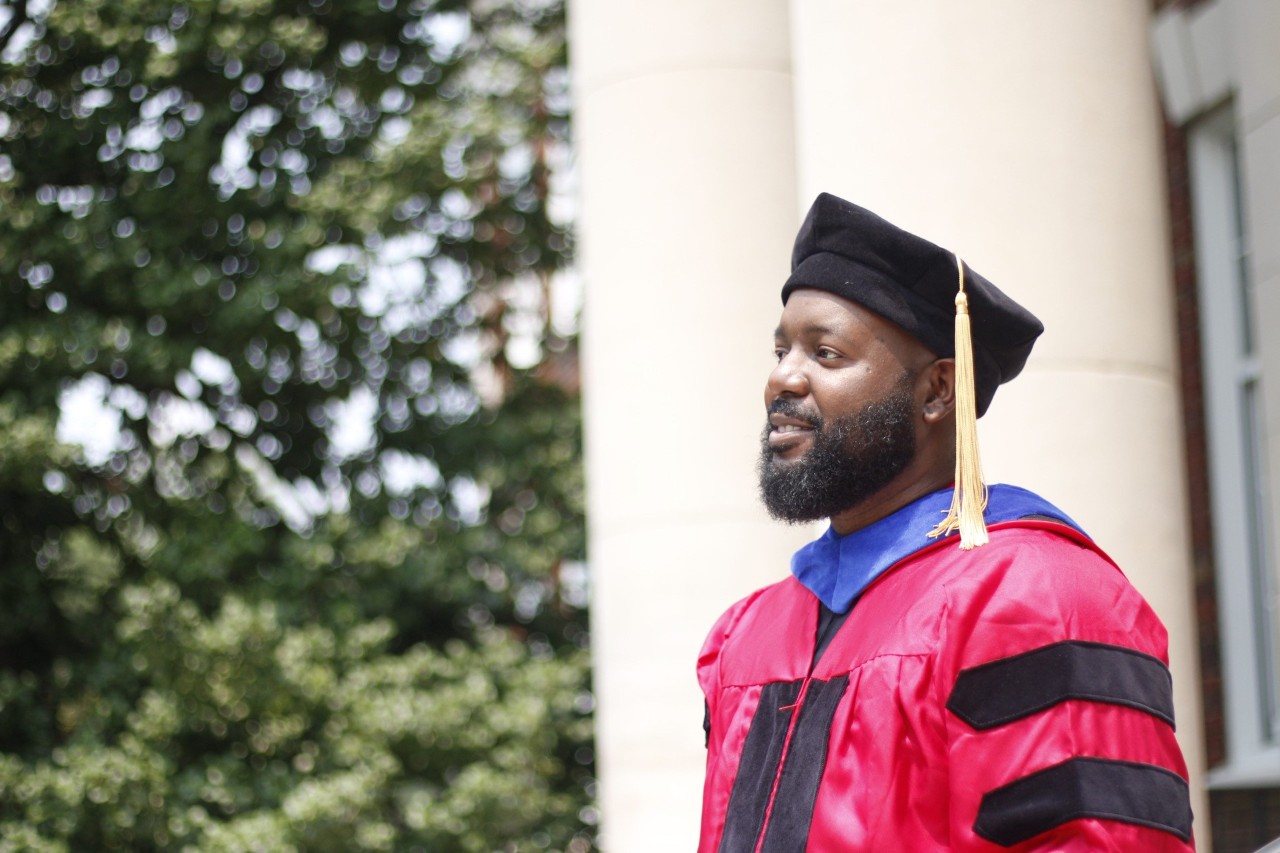 Maurice Adkins in doctoral gown.