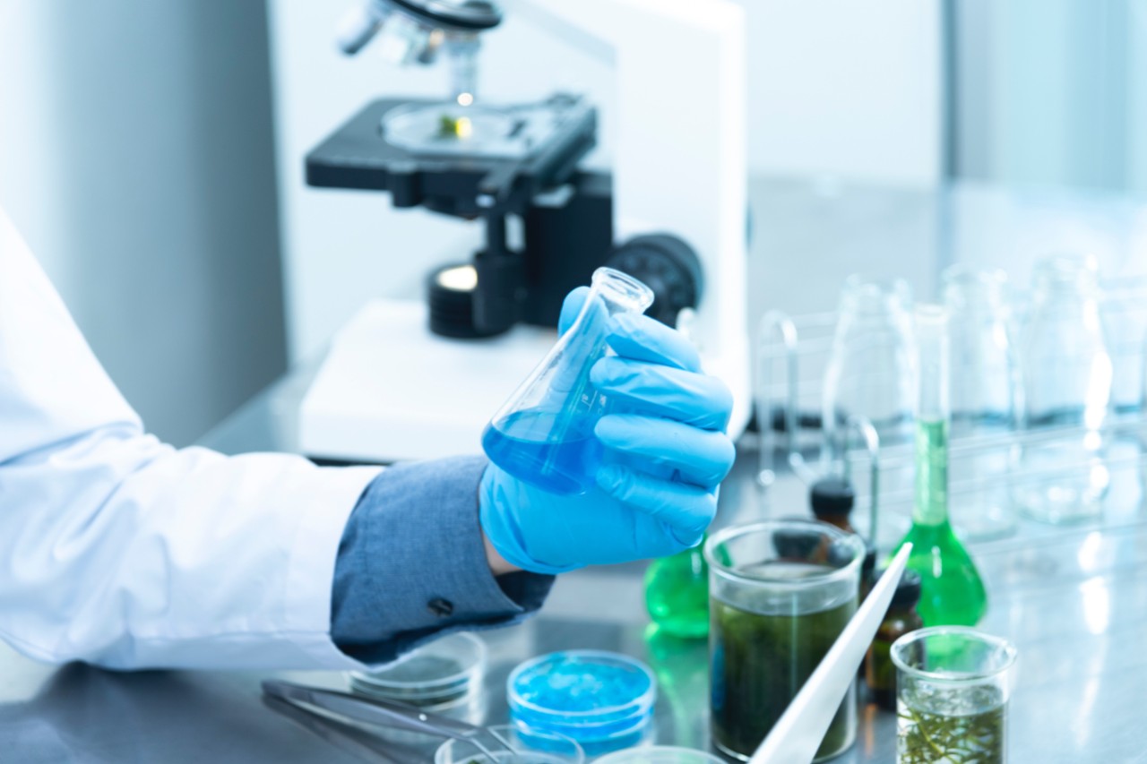 a researcher working with test tubes in a lab